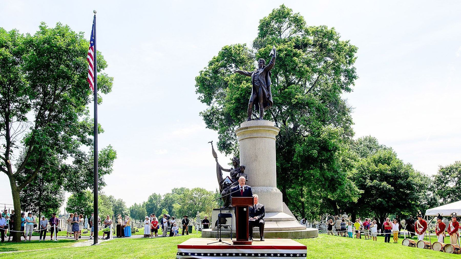 Presenter speaking to crowd at grave of Francis Scott Key