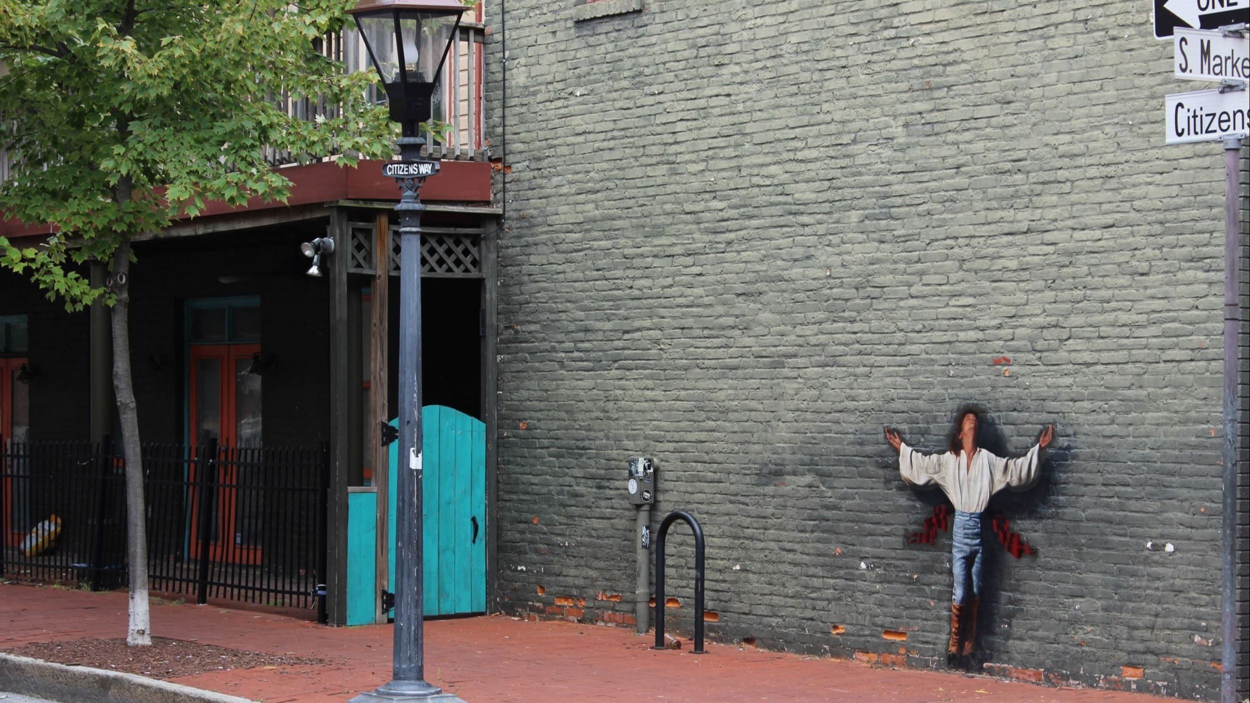 Painting on a brick wall along the street