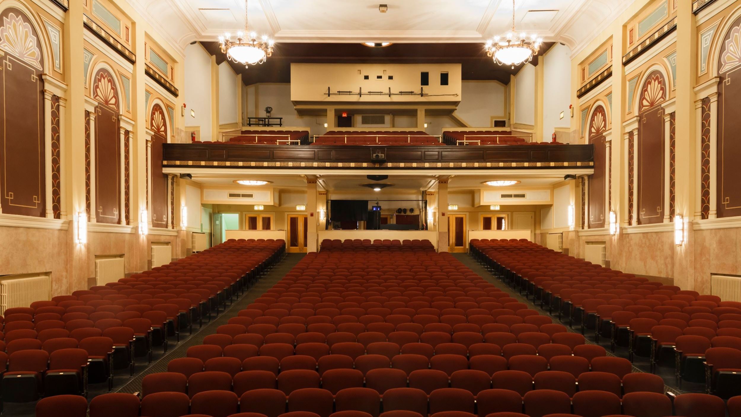 Large, ornate theater with red chairs