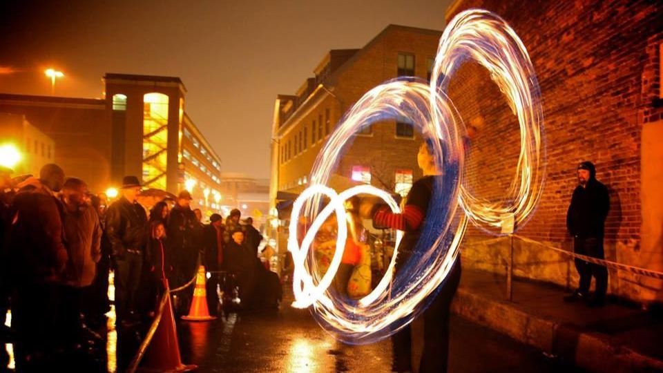 People gathered watching a street performer