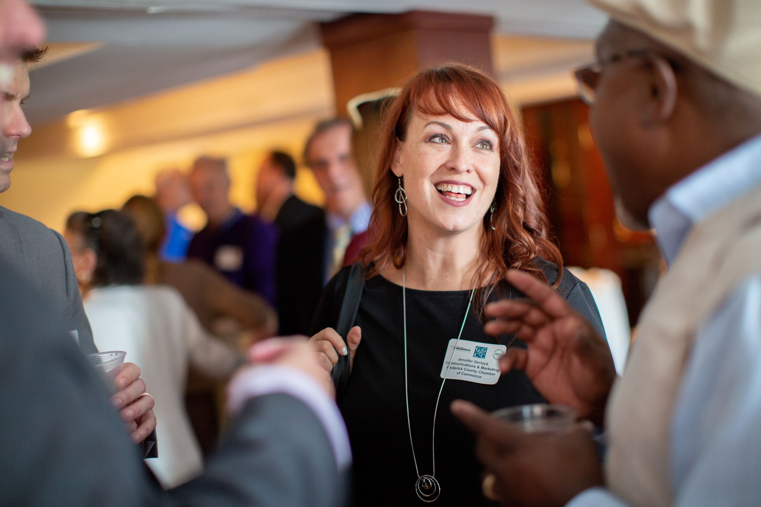 People conversing in a crowded room
